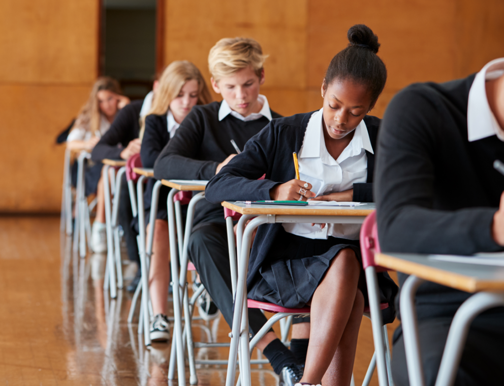 Photo showing a row of students taking an exam