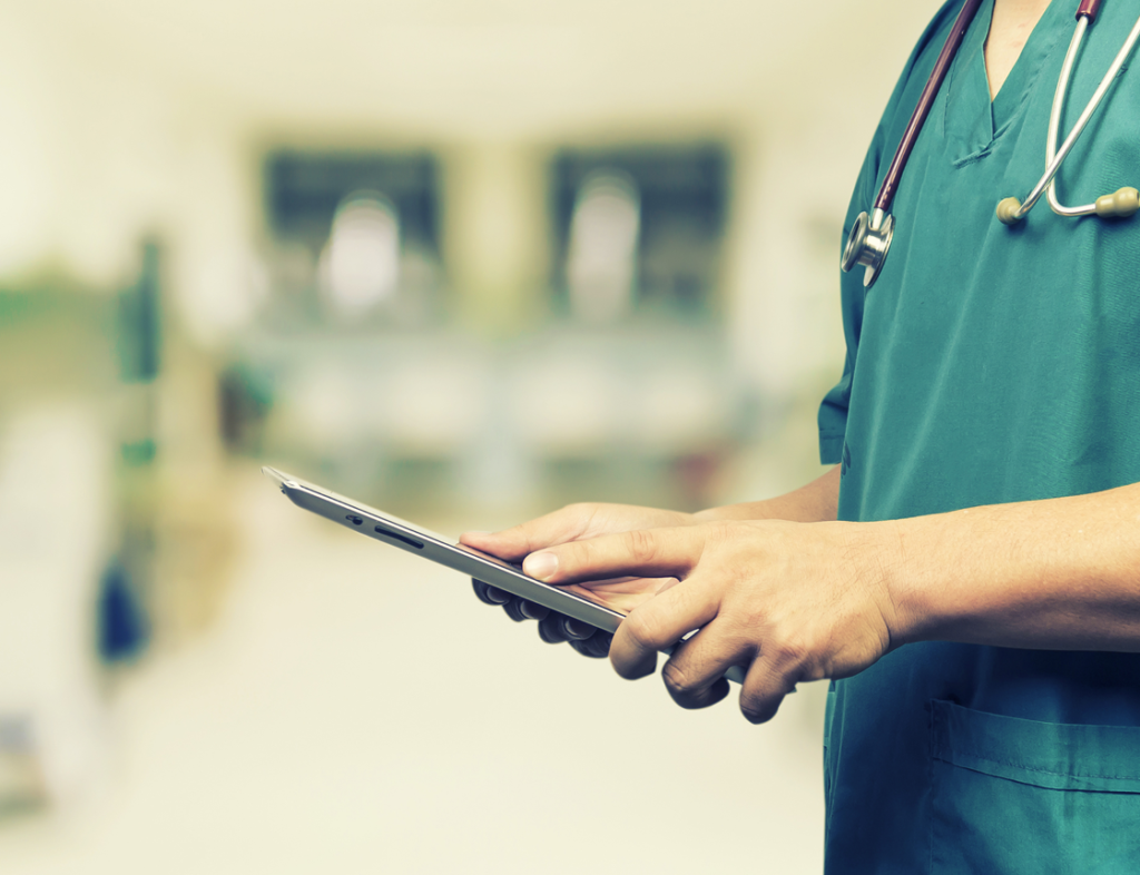 Photo showing a doctor using a tablet