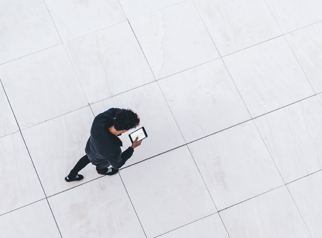 Photo of man walking with a phone