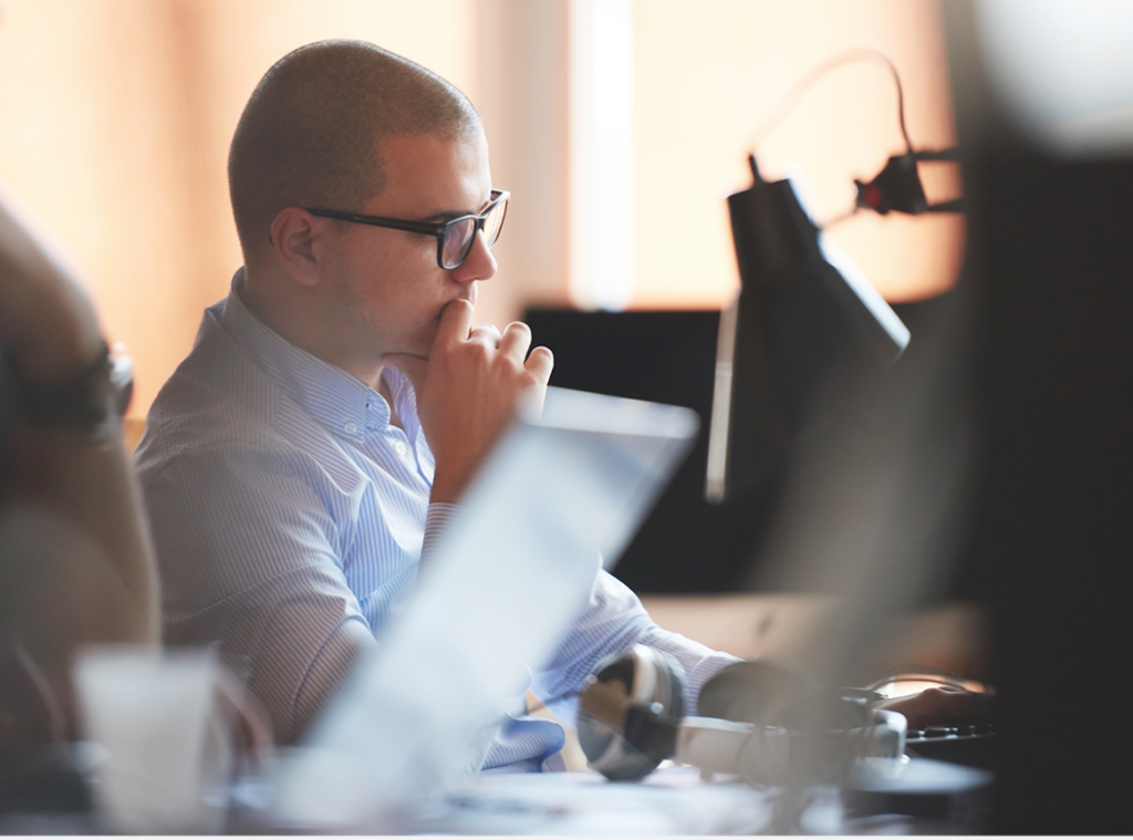 Photo showing a man concentrating at his computer