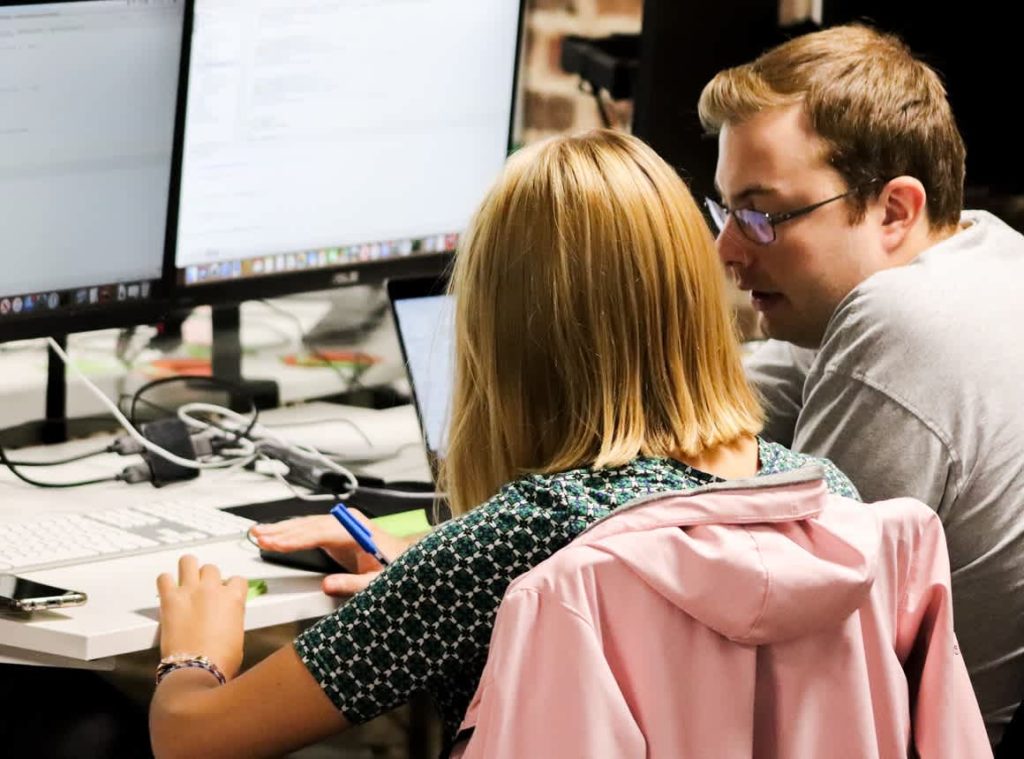 Photo of colleagues at a computer