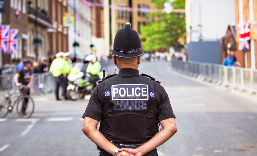 Photo showing a British Police Officer stanging in a road