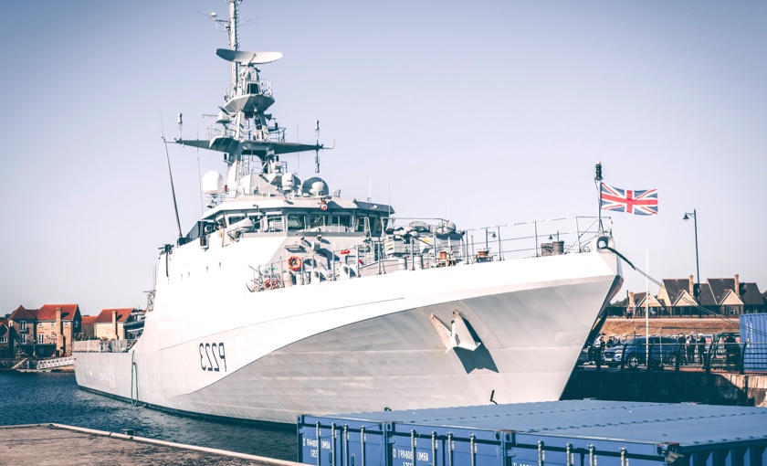 Photo showing a Royal Navy ship at a dock