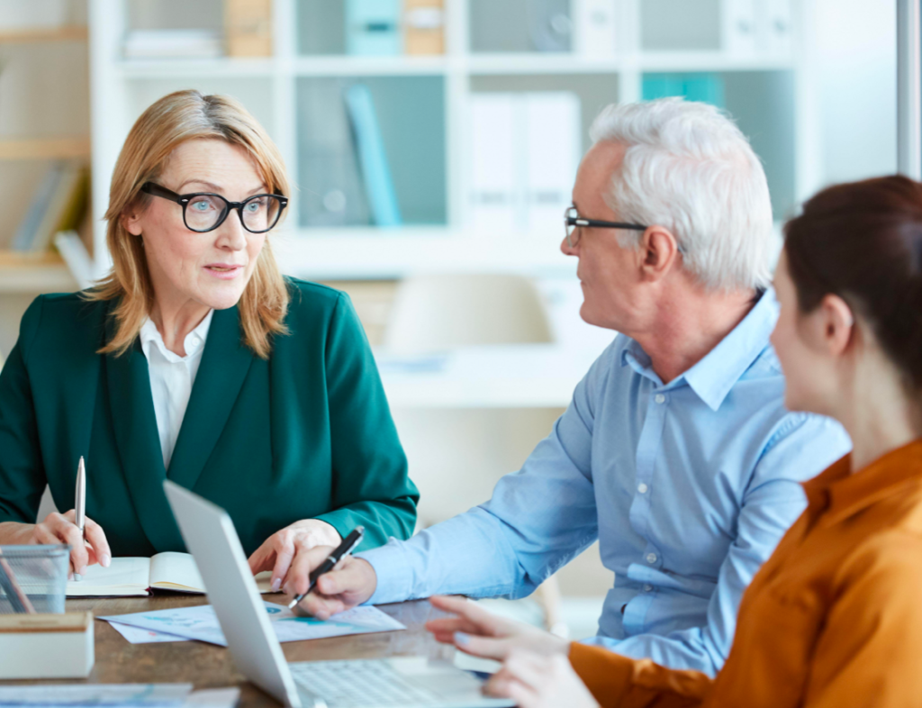 Photo showing a citizens advice worker speaking to two customers