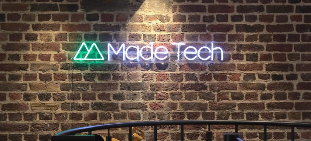 Made Tech neon on a brick wall
