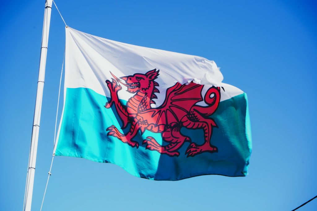Photo of Wales flag flying in blue sky