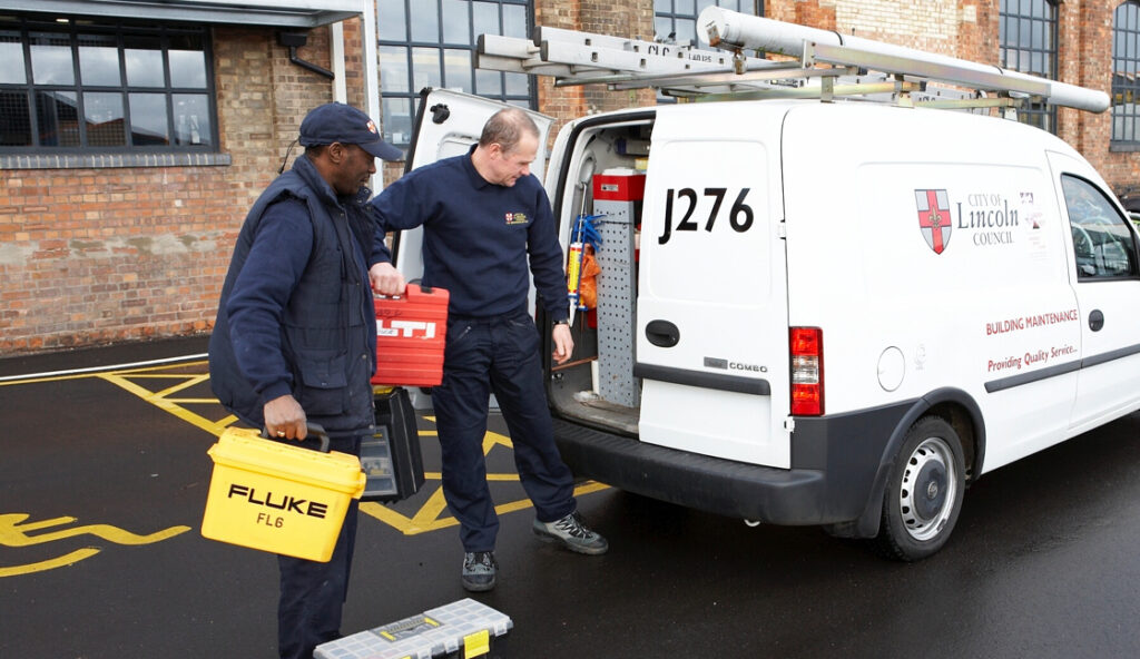 Two men loading a City of Lincoln Council van